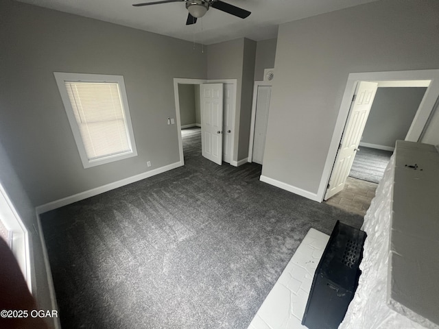 1816 S Connor Ave, Joplin, MO 64804 - unfurnished bedroom with dark colored carpet, baseboards, and a ceiling fan