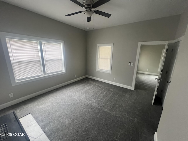 1816 S Connor Ave, Joplin, MO 64804 - unfurnished room featuring dark colored carpet, baseboards, plenty of natural light, and ceiling fan