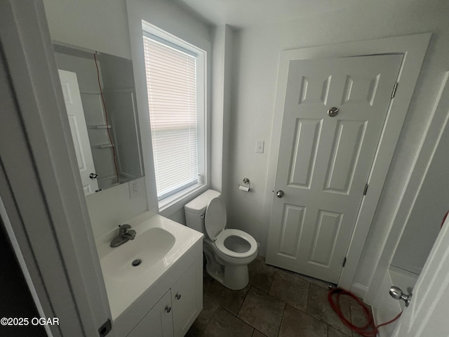 1816 S Connor Ave, Joplin, MO 64804 - bathroom featuring vanity, toilet, and stone finish floors