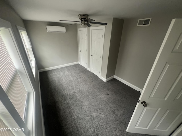 1816 S Connor Ave, Joplin, MO 64804 - unfurnished bedroom featuring carpet flooring, an AC wall unit, baseboards, and a ceiling fan