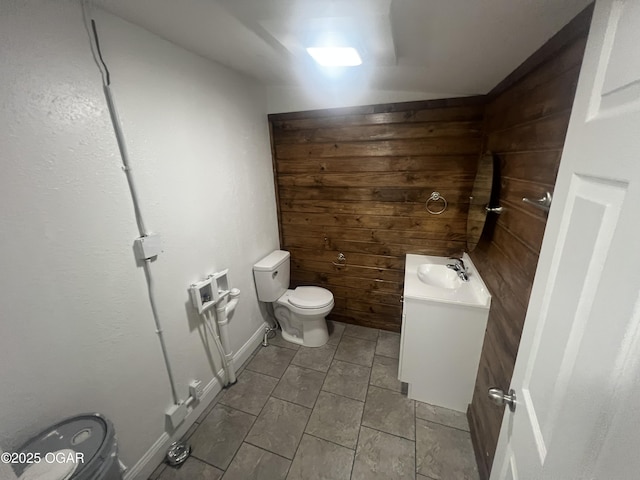 1816 S Connor Ave, Joplin, MO 64804 - bathroom featuring toilet, vanity, wood walls, and tile patterned floors
