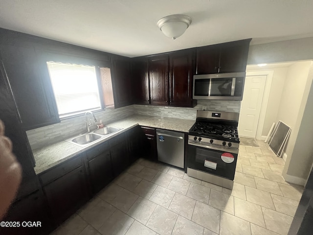 1816 S Connor Ave, Joplin, MO 64804 - kitchen with appliances with stainless steel finishes, a sink, and tasteful backsplash