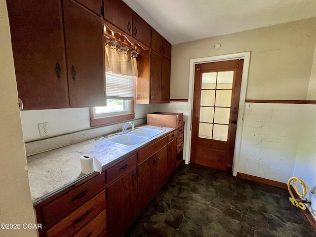 220 N Kentucky St, Carterville, MO 64835 - kitchen featuring a sink, dark stone finish flooring, light countertops, and baseboards