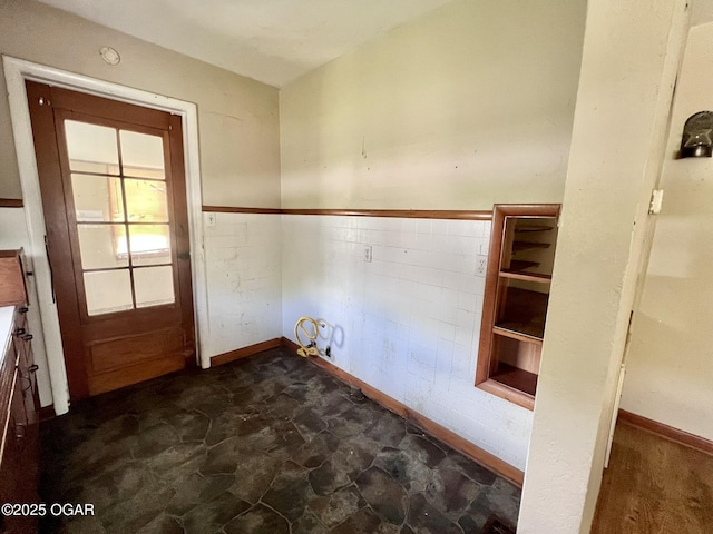220 N Kentucky St, Carterville, MO 64835 - laundry room featuring wainscoting, dark stone finish flooring, and baseboards