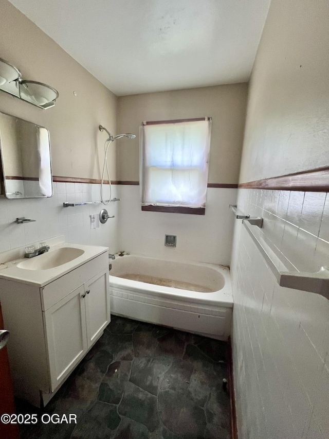 220 N Kentucky St, Carterville, MO 64835 - bathroom featuring tile walls, a tub, vanity, and wainscoting
