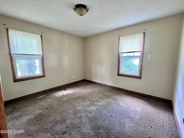 220 N Kentucky St, Carterville, MO 64835 - carpeted spare room featuring baseboards and a textured ceiling