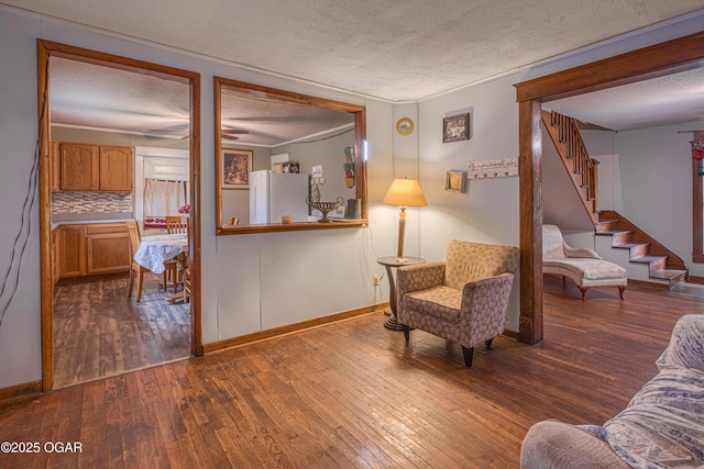 17279 Jackpine Rd, Carthage, MO 64836 - living area with a textured ceiling, wood-type flooring, stairway, baseboards, and ceiling fan