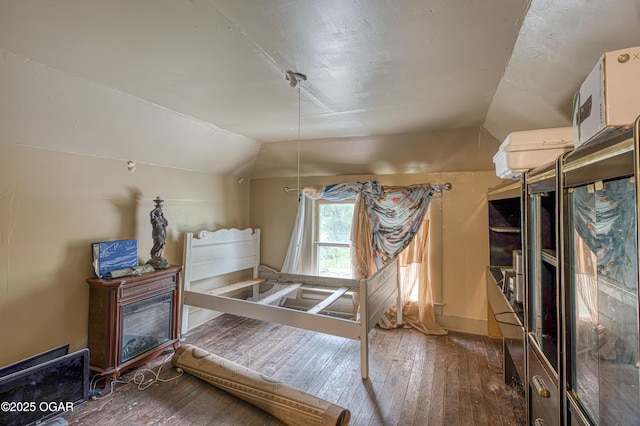 17279 Jackpine Rd, Carthage, MO 64836 - bedroom with vaulted ceiling, wood-type flooring, and baseboards