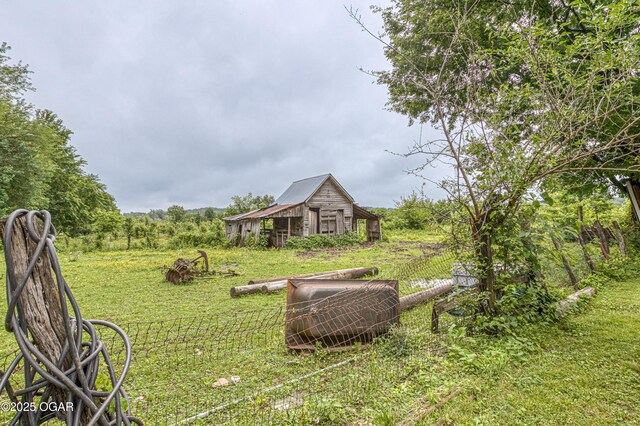 17279 Jackpine Rd, Carthage, MO 64836 - view of yard featuring a barn and an outbuilding