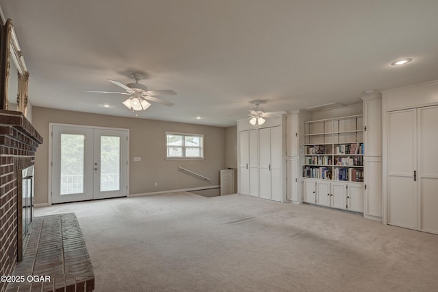 2521 Wisconsin Ave, Joplin, MO 64804 - unfurnished living room with ceiling fan, carpet, a brick fireplace, recessed lighting, and french doors