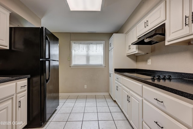 2521 Wisconsin Ave, Joplin, MO 64804 - kitchen with black appliances, under cabinet range hood, baseboards, dark countertops, and light tile patterned floors