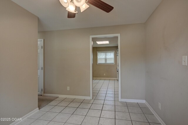 2521 Wisconsin Ave, Joplin, MO 64804 - empty room with a ceiling fan, light tile patterned floors, and baseboards