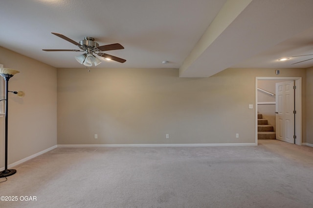 2521 Wisconsin Ave, Joplin, MO 64804 - empty room featuring a ceiling fan, light colored carpet, stairs, and baseboards