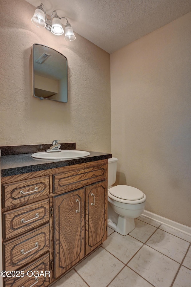 2521 Wisconsin Ave, Joplin, MO 64804 - half bath featuring vanity, toilet, a textured ceiling, a textured wall, and tile patterned flooring