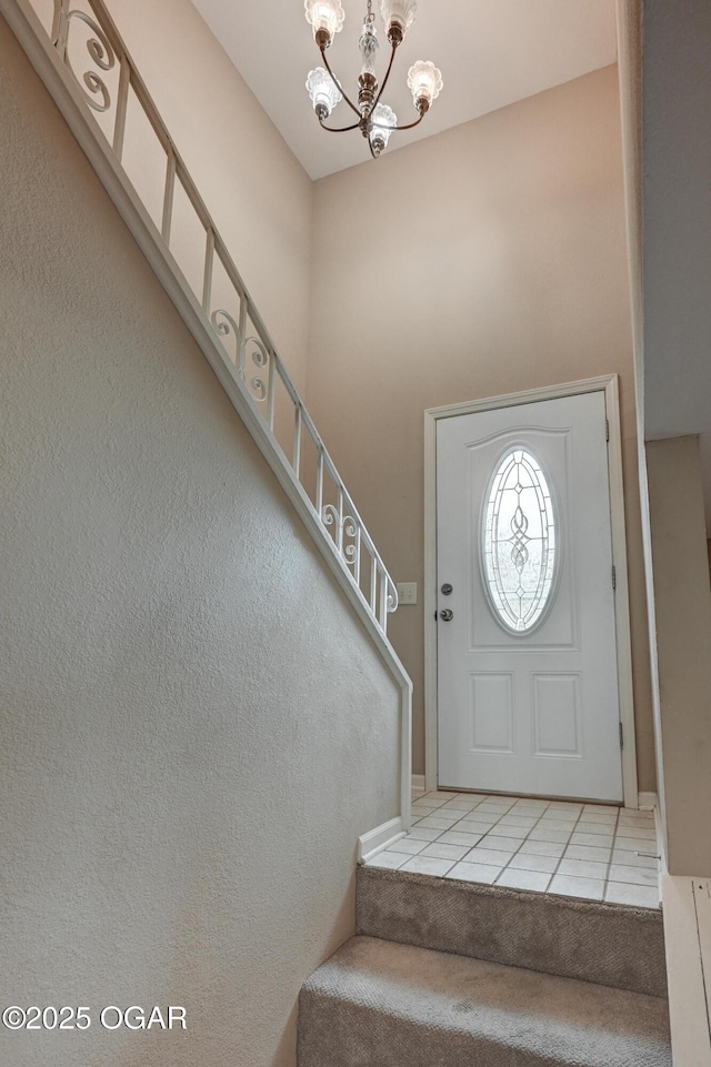 2521 Wisconsin Ave, Joplin, MO 64804 - carpeted entryway with tile patterned floors, a chandelier, and stairs