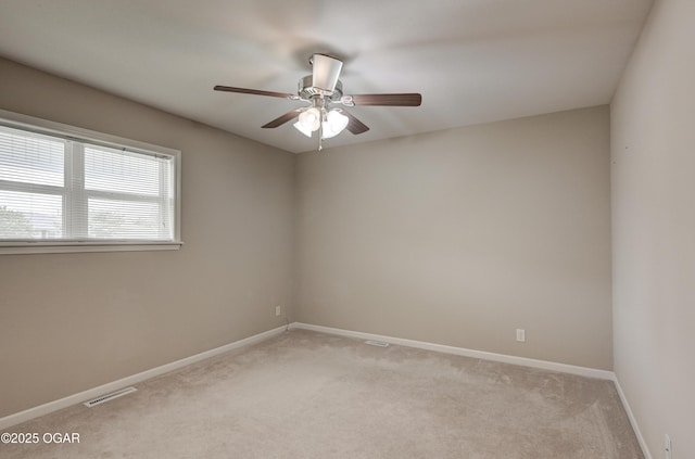 2521 Wisconsin Ave, Joplin, MO 64804 - spare room featuring light colored carpet, a ceiling fan, and baseboards