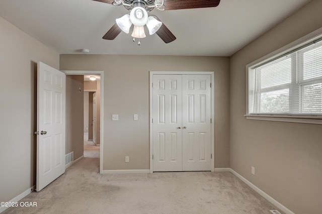 2521 Wisconsin Ave, Joplin, MO 64804 - unfurnished bedroom featuring light colored carpet, a closet, baseboards, and ceiling fan