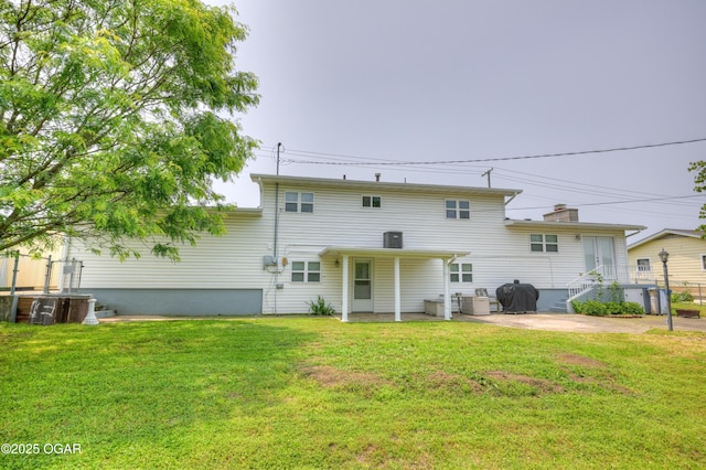 2521 Wisconsin Ave, Joplin, MO 64804 - back of property featuring a yard, a patio area, and cooling unit