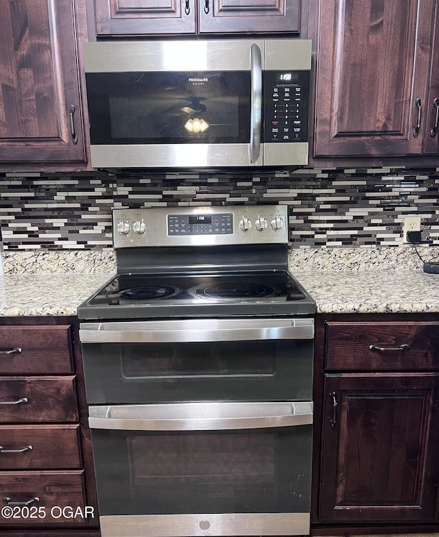 2038 W Trolley Car Ln, Carthage, MO 64836 - kitchen with stainless steel appliances, tasteful backsplash, dark brown cabinets, and light stone counters