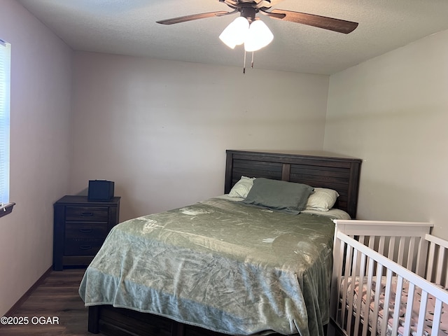 2038 W Trolley Car Ln, Carthage, MO 64836 - bedroom featuring dark wood finished floors, ceiling fan, and a textured ceiling