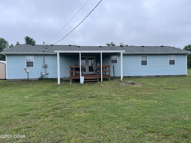 2038 W Trolley Car Ln, Carthage, MO 64836 - rear view of house featuring a wooden deck, a lawn, and roof with shingles