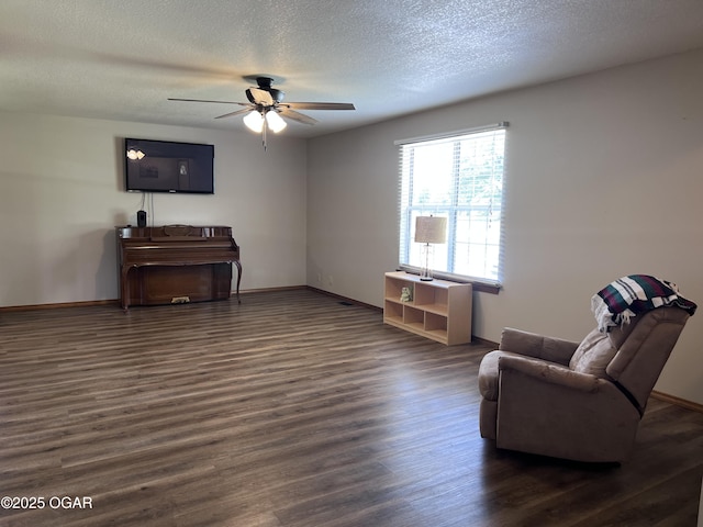 2038 W Trolley Car Ln, Carthage, MO 64836 - living area featuring a ceiling fan, dark wood-type flooring, and a textured ceiling