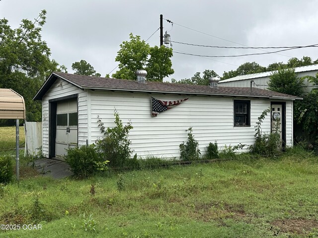 1003 Adams Ave, Seneca, MO 64865 - view of property exterior with a garage