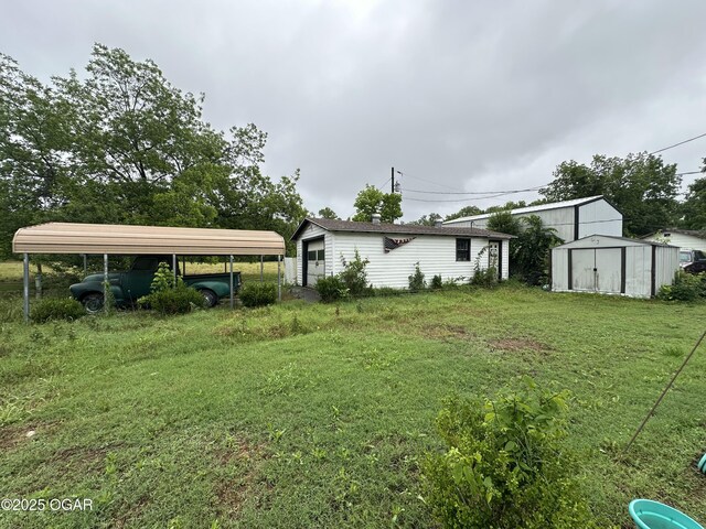 1003 Adams Ave, Seneca, MO 64865 - view of grassy yard with a detached carport