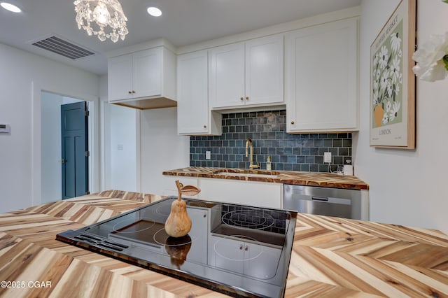 207 S Hall St, Webb City, MO 64870 - kitchen featuring wooden counters, stainless steel dishwasher, white cabinetry, backsplash, and recessed lighting