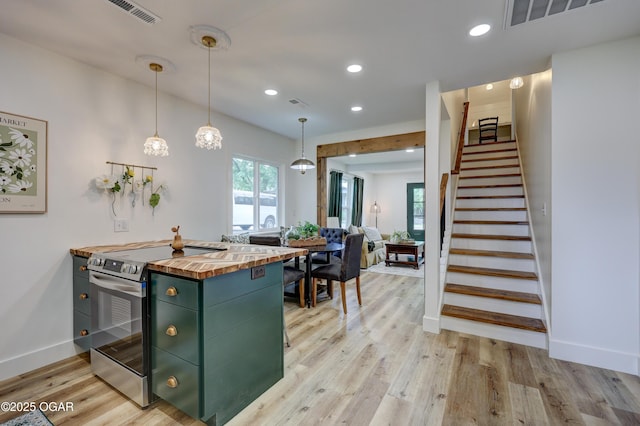 207 S Hall St, Webb City, MO 64870 - kitchen featuring wood counters, stainless steel electric range oven, green cabinets, light wood-style floors, and recessed lighting