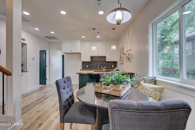 207 S Hall St, Webb City, MO 64870 - dining space with healthy amount of natural light, light wood-type flooring, recessed lighting, and baseboards