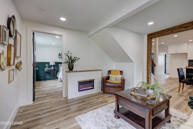 207 S Hall St, Webb City, MO 64870 - living area with light wood finished floors, recessed lighting, a glass covered fireplace, and baseboards