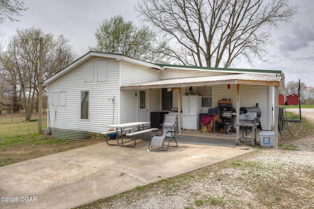 241 SE 40th Rd, Lamar, MO 64759 - rear view of house with a patio area