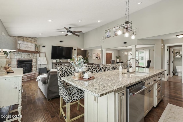 7870 County Lane 287, Carl Junction, MO 64834 - kitchen with a sink, a stone fireplace, a ceiling fan, lofted ceiling, and light stone counters
