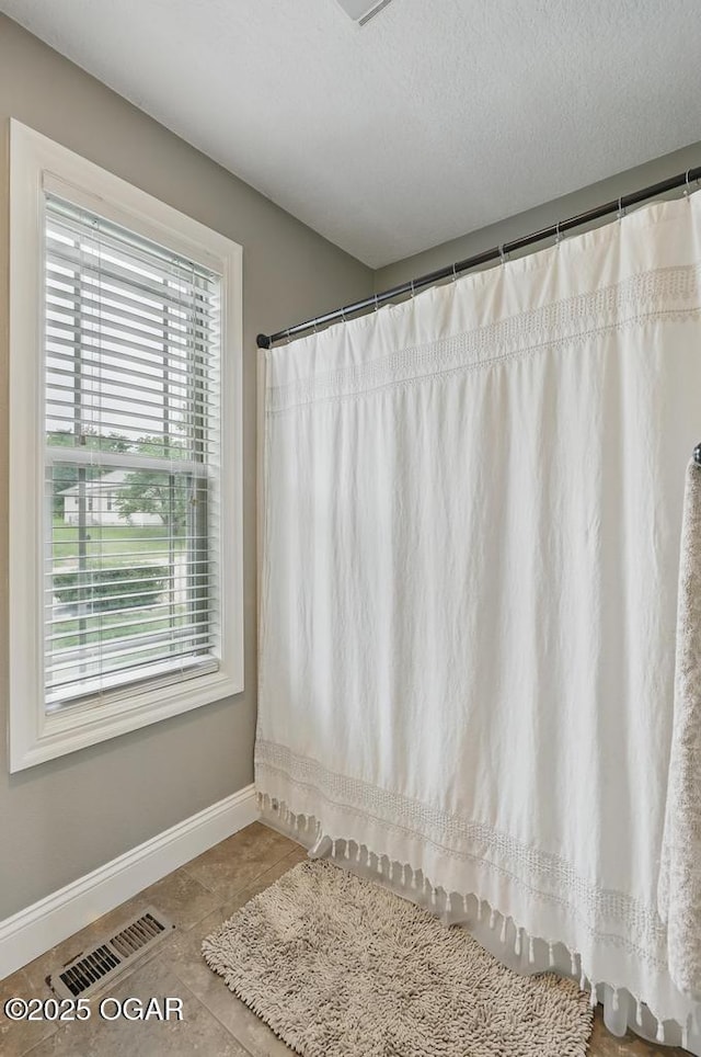 7870 County Lane 287, Carl Junction, MO 64834 - full bathroom with baseboards, tile patterned flooring, and a shower with shower curtain