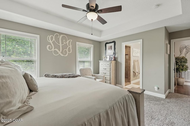 7870 County Lane 287, Carl Junction, MO 64834 - carpeted bedroom with a raised ceiling, baseboards, ceiling fan, and ensuite bathroom
