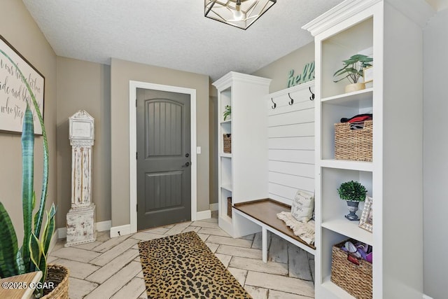 7870 County Lane 287, Carl Junction, MO 64834 - mudroom featuring a textured ceiling and baseboards