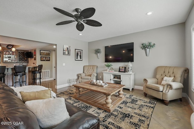 7870 County Lane 287, Carl Junction, MO 64834 - living area with wet bar, baseboards, ceiling fan, recessed lighting, and concrete flooring