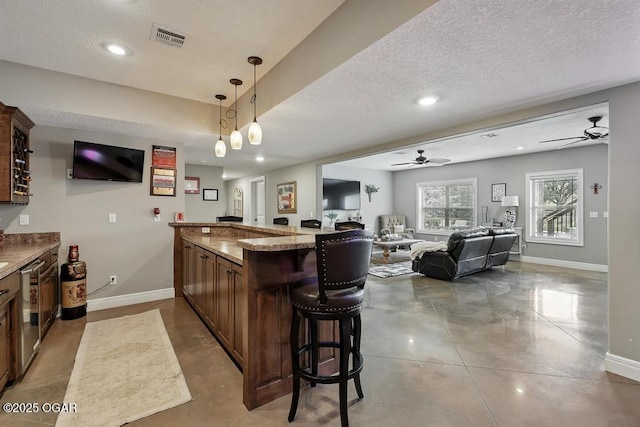 7870 County Lane 287, Carl Junction, MO 64834 - kitchen featuring ceiling fan, a kitchen breakfast bar, baseboards, a peninsula, and recessed lighting
