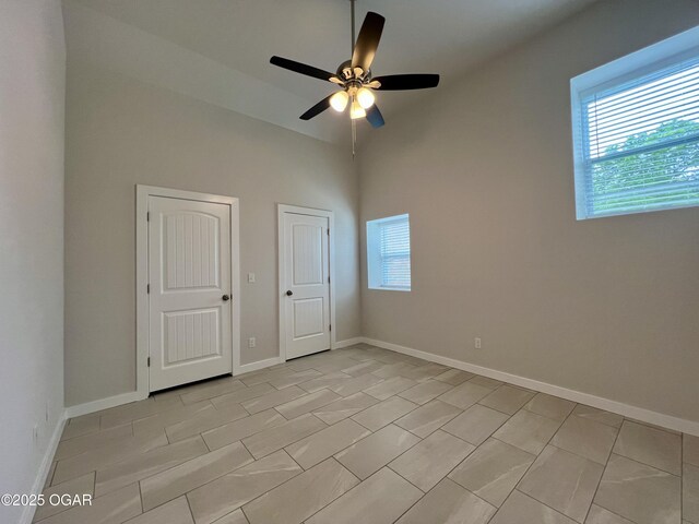 204 Webb St, Duenweg, MO 64841 - spare room with a ceiling fan, baseboards, and high vaulted ceiling