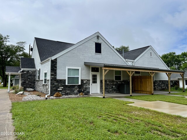 204 Webb St, Duenweg, MO 64841 - view of front facade with a front lawn, stone siding, and roof with shingles