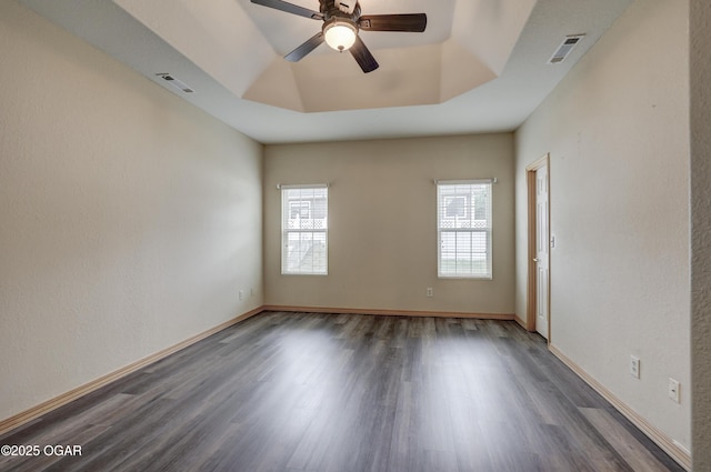 4320 Wisteria Way, Joplin, MO 64801 - empty room with wood finished floors, a ceiling fan, a tray ceiling, and baseboards