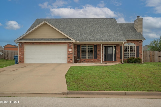 330 Sadie Ln, Webb City, MO 64870 - view of front of home with brick siding, driveway, an attached garage, and a chimney