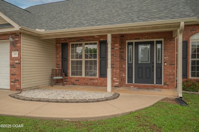 330 Sadie Ln, Webb City, MO 64870 - entrance to property with a shingled roof, brick siding, and covered porch