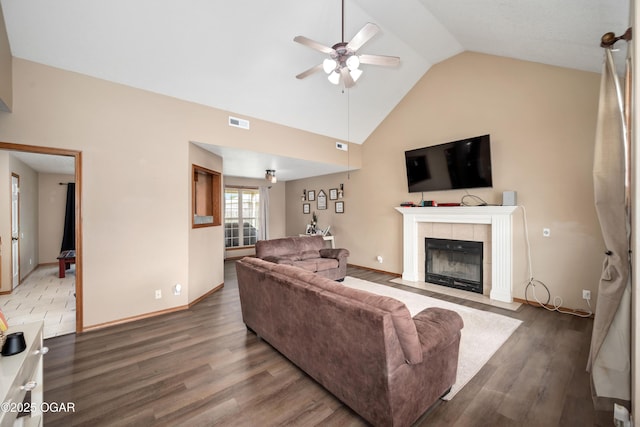 330 Sadie Ln, Webb City, MO 64870 - living area featuring ceiling fan, wood finished floors, a tile fireplace, baseboards, and high vaulted ceiling