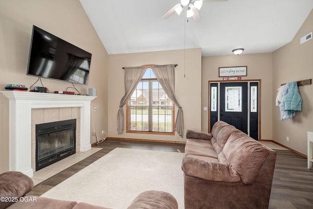 330 Sadie Ln, Webb City, MO 64870 - living area featuring wood finished floors, a tile fireplace, a ceiling fan, lofted ceiling, and baseboards