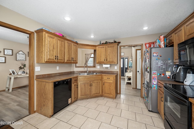 330 Sadie Ln, Webb City, MO 64870 - kitchen with black appliances, a sink, brown cabinets, recessed lighting, and dark countertops