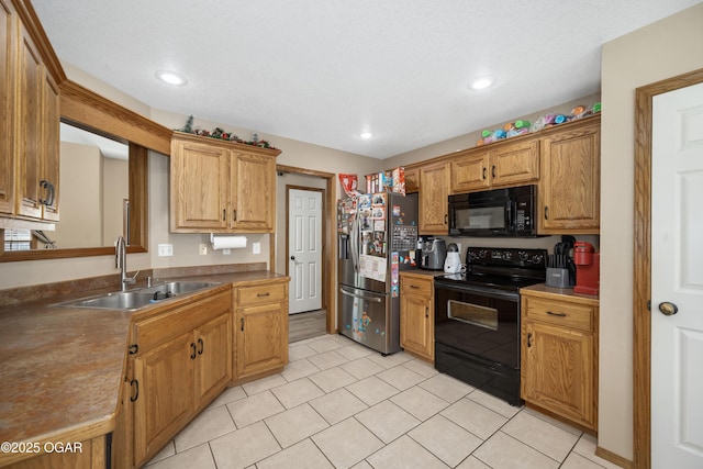 330 Sadie Ln, Webb City, MO 64870 - kitchen featuring black appliances, a sink, light tile patterned floors, recessed lighting, and brown cabinetry