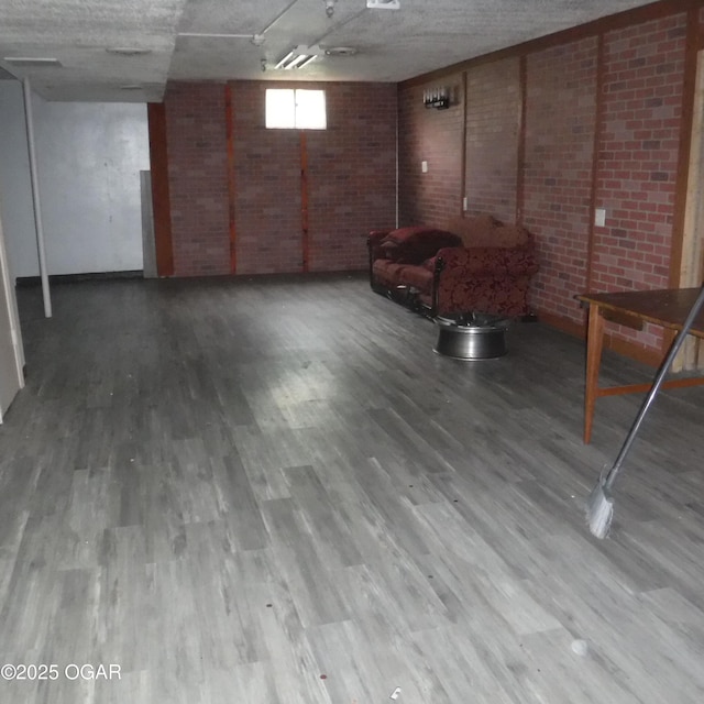 105 N Pearl Ave, Joplin, MO 64801 - below grade area featuring wood finished floors, brick wall, and baseboards