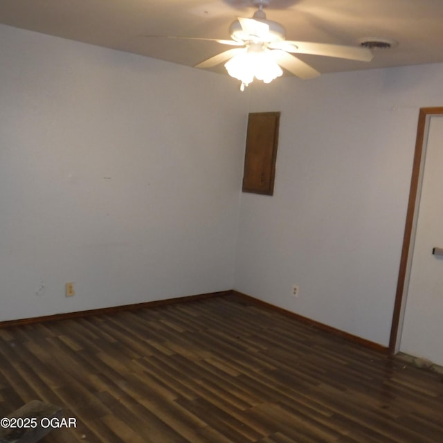 105 N Pearl Ave, Joplin, MO 64801 - spare room featuring ceiling fan, dark wood-style flooring, and baseboards